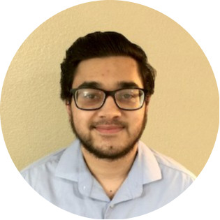 Student in glasses and blue shirt with short beard.