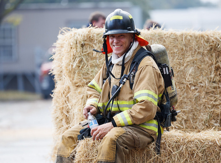 male firefighter student talking to child in gear