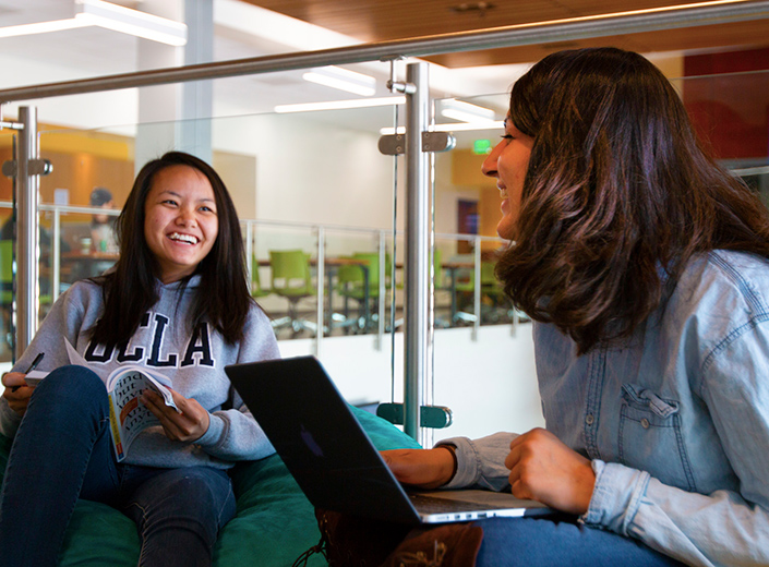 two female students laughing inside