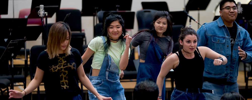 Dancing students Dancing students in a music classroom. Music stands are behind them.